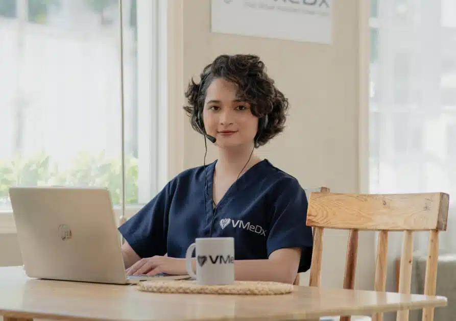 About - Us A VMeDx virtual medical receptionist working with coffee.