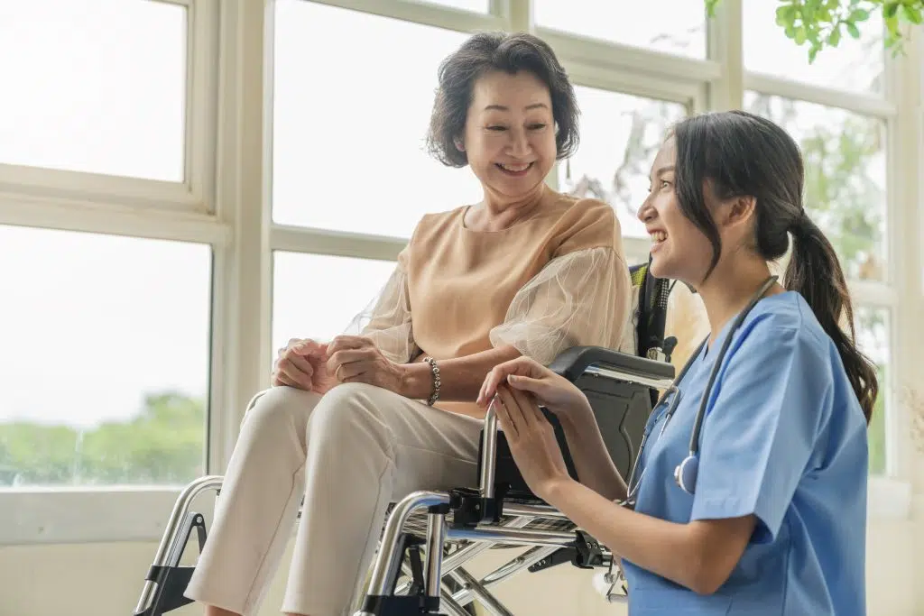 caregiver taking care of an old patient, best virtual medical scribes