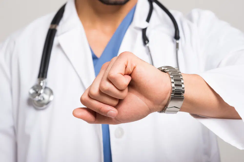 doctor looking at his watch