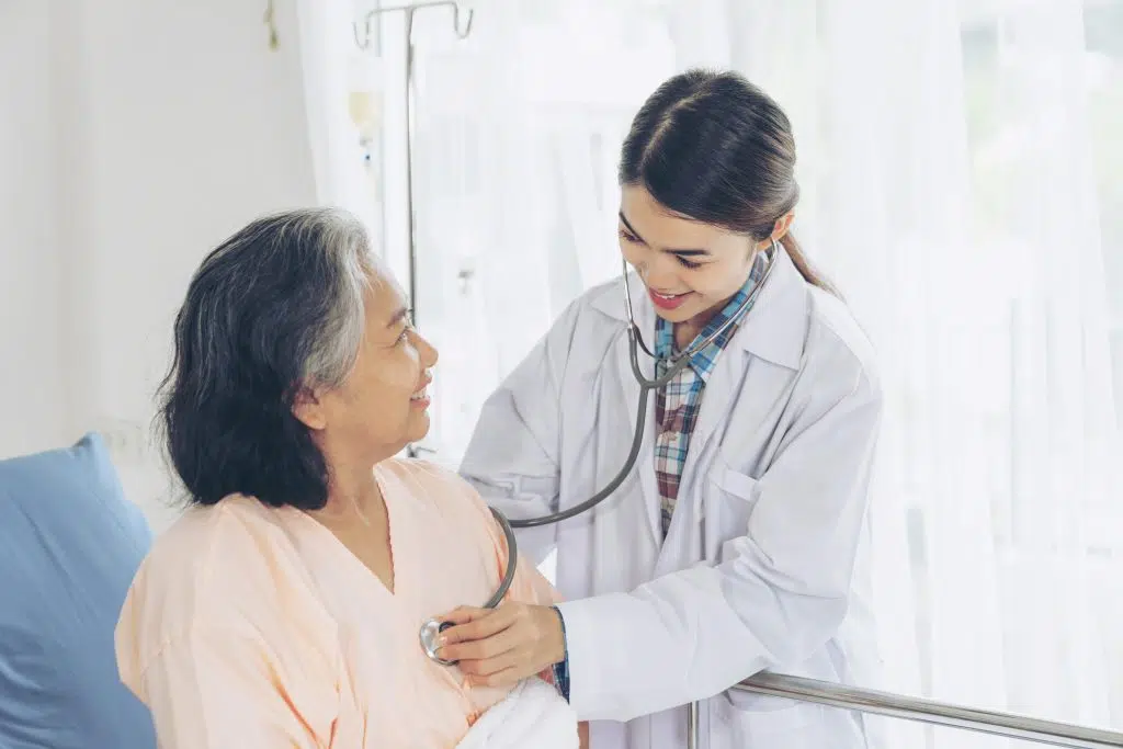 elderly female smiling at the doctor, cardiologist medical virtual scribe