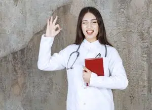 A smiling doctor showing an OK sign, representing confidence and efficiency with the help of a medical virtual scribe