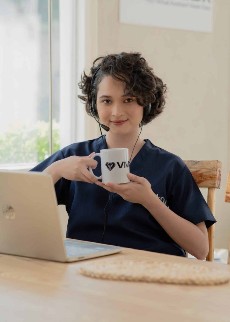 virtual assistant holding a cup while using a laptop, medical scribe virtual