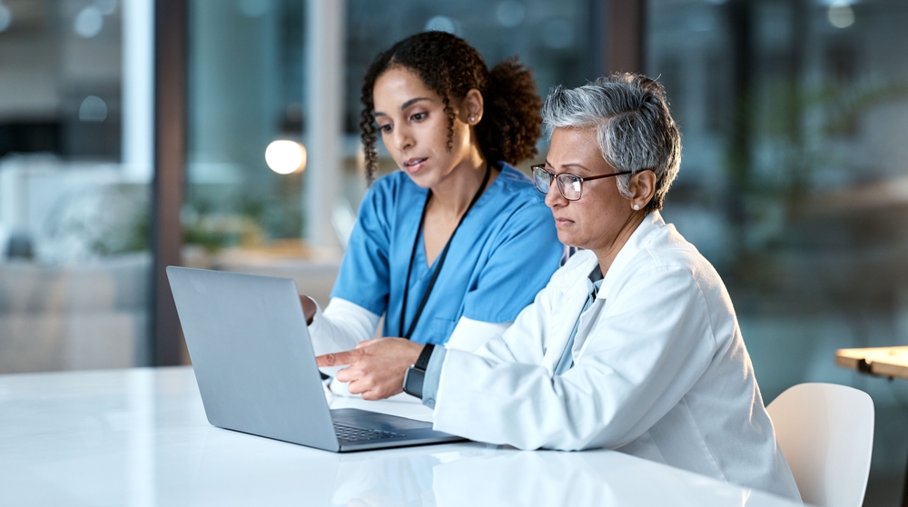 A doctor guiding a virtual medical assistant trainee