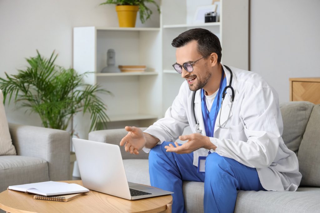 A medical virtual assistant home-based supports a doctor in video chatting with their patient at home.