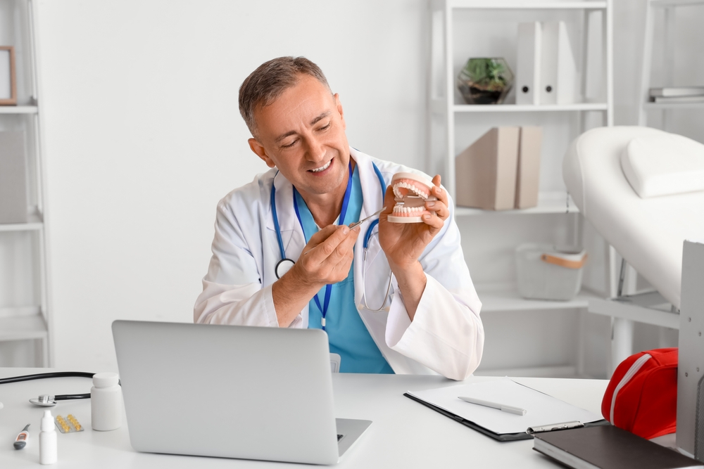 Dental virtual assistant, with jaw model video chatting on the office.