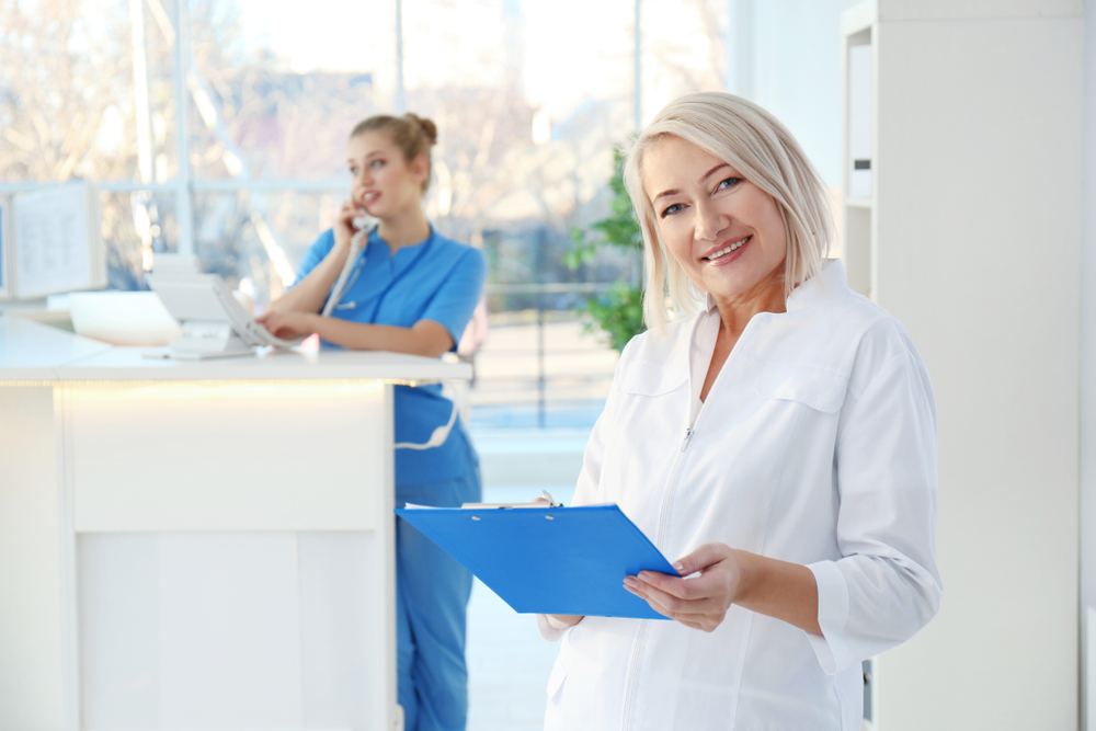 Female receptionist and trainee in hospital