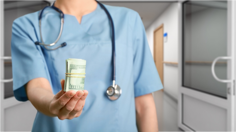 Medical Scribe holding her salary.