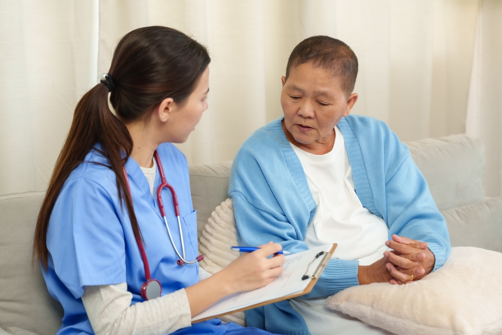 Medical scribe talking to patient, documenting about the patients concern.