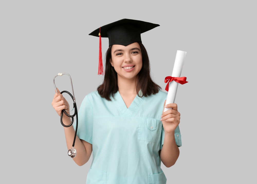 Medical student holding a diploma.