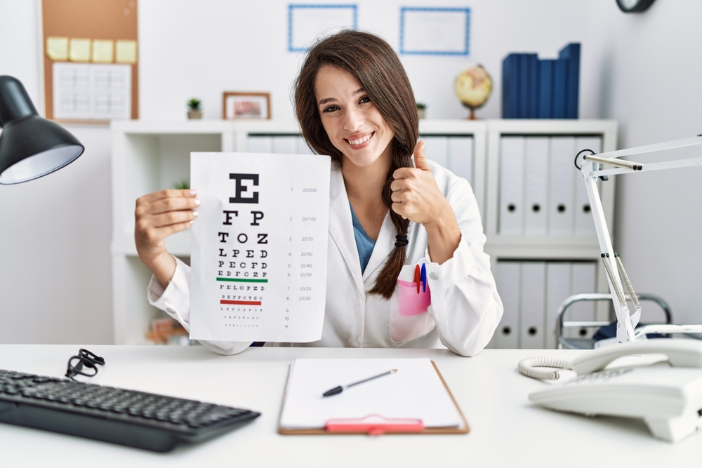 Ophthalmologist medical virtual scribe holding an eyesight test at her desk.