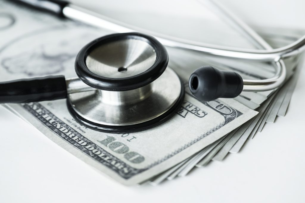 close up picture of a stethoscope on a cash, how much do virtual medical scribes make