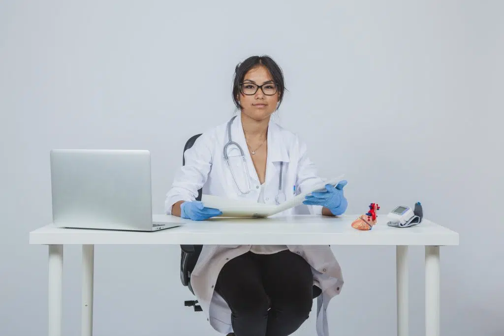 a doctor sitting in desk representing medical virtual scribes
