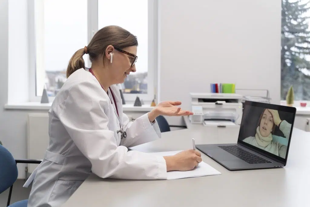 a doctor video calling someone representing "what is a virtual medical scribe"