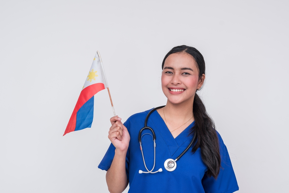 filipino virtual medical assistant holding a flag of the philippines. 