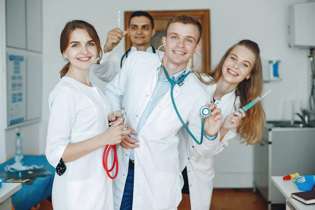 a group of group of doctors, virtual experienced medical scribe holding medical equipment