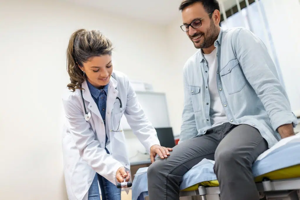 a doctor checking a patients knee, podiatrist medical virtual scribe