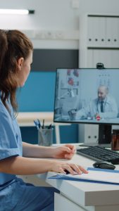 nurse talking to doctor via video call, virtual medical scribe company