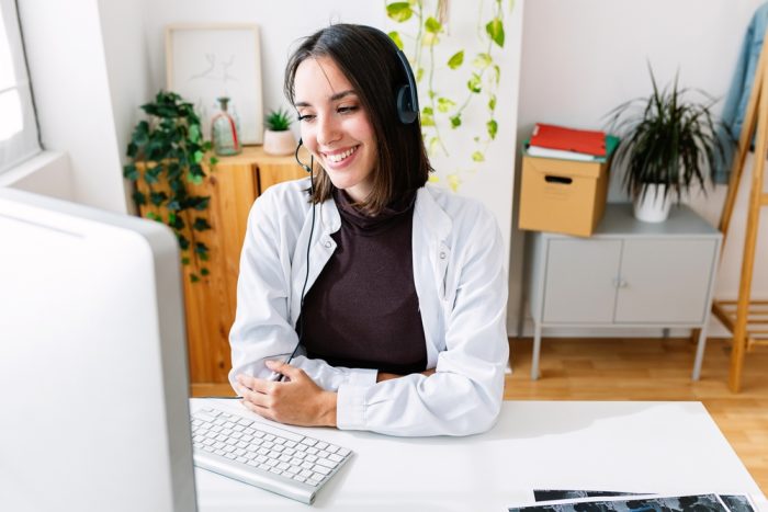 virtual medical scribe part time consults with her client via laptop on a table