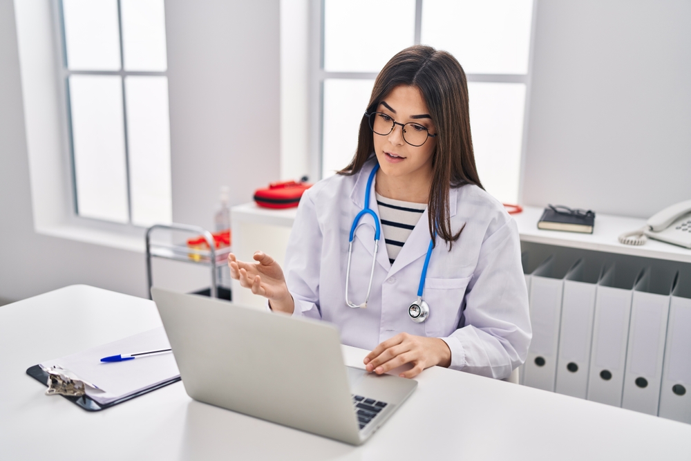 Medical assistant virtual jobs involve using a laptop to have video calls at the clinic.