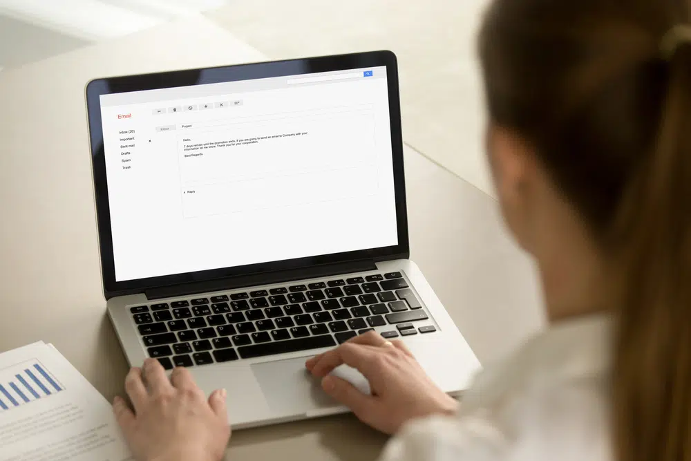 a doctor replying emails on her laptop