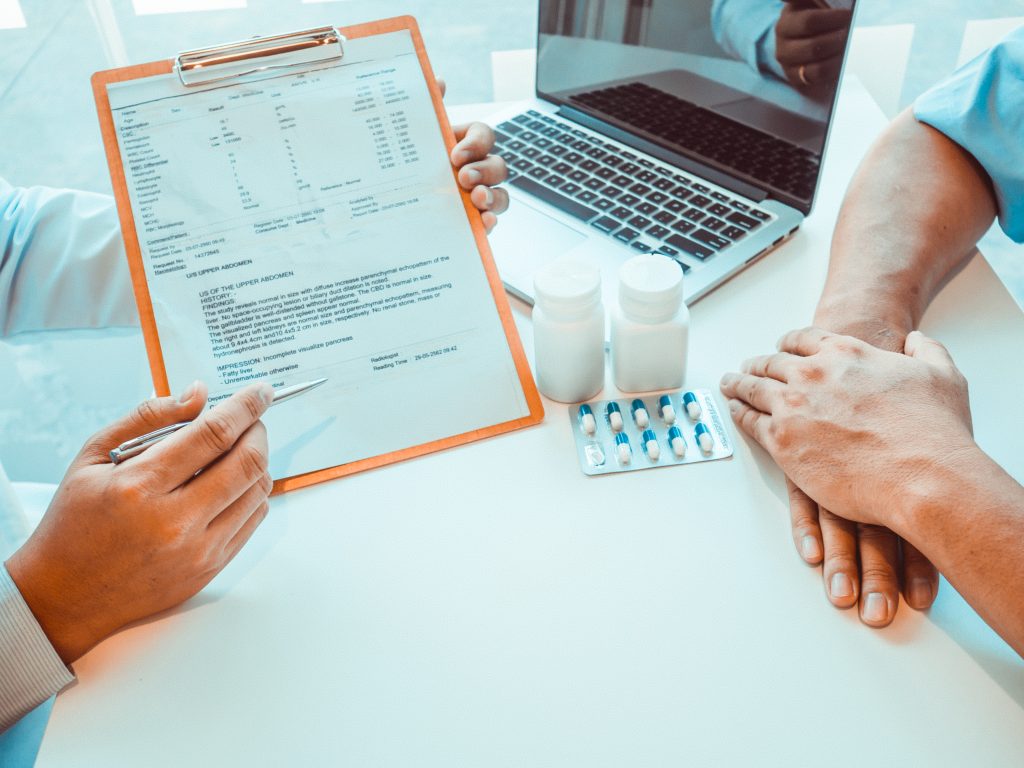 cropped hands doctor showing documents, prior authorization for medication
