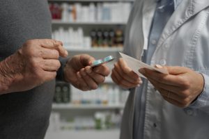 senior-man-consulting-female-pharmacist-medication, prior authorization for medication 