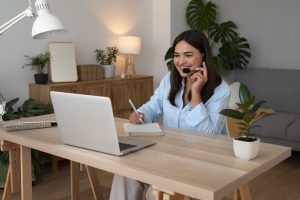 virtual assistant having a call at home with laptop and headset