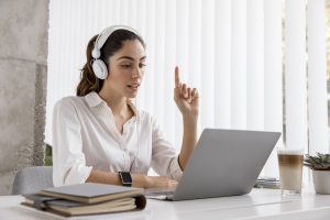 virtual receptionist working with headphones and laptop