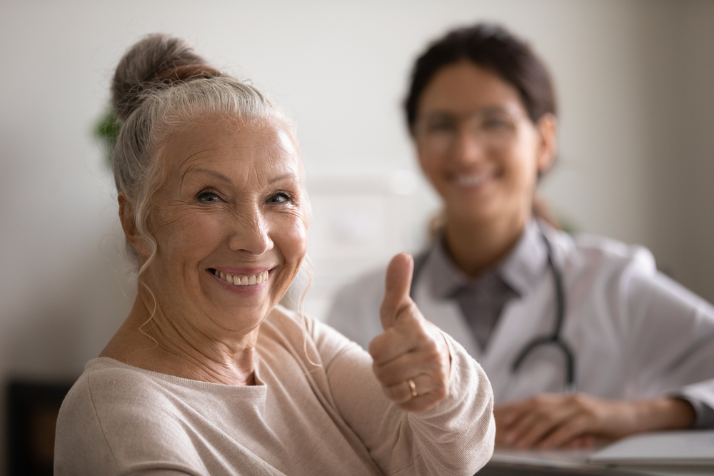 A female satisfied showing thumbs up.