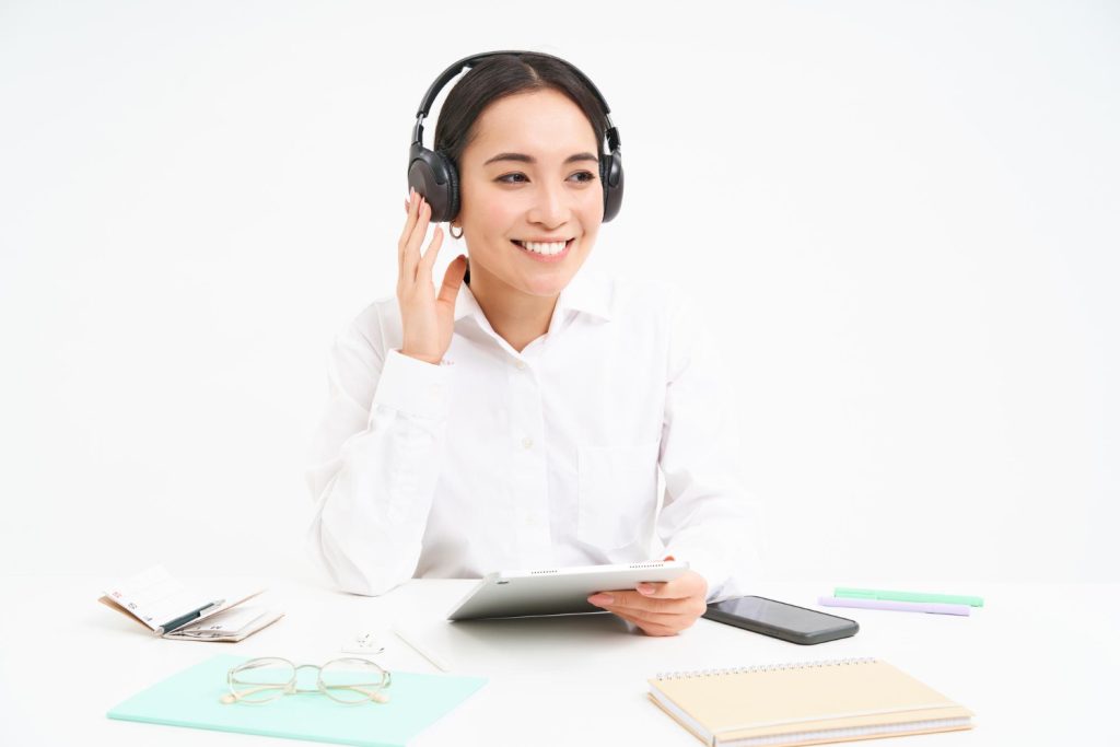 a certified medical transcriptionist woman wearing headphone while using her laptop