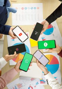 People hold smartphones in different brands and operating systems with various logos of social applications, Twitter, Instagram, TikTok, Linkedin, Line, Youtube, healthcare social media marketing 
