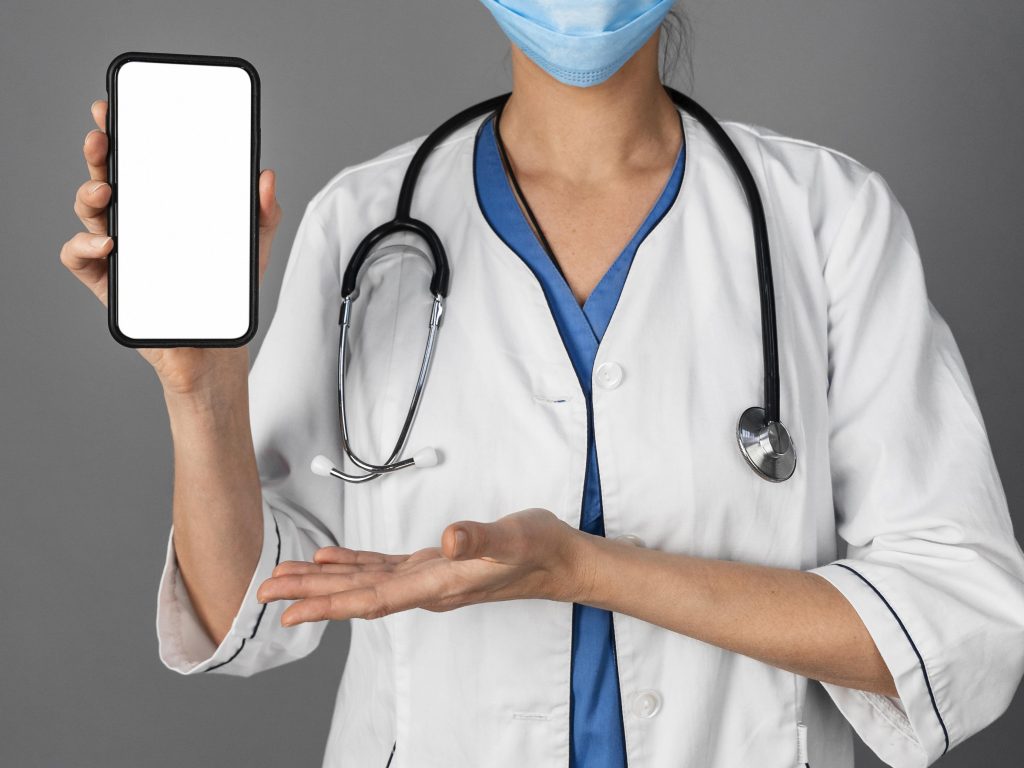 female doctor holding her phone, social media in healthcare