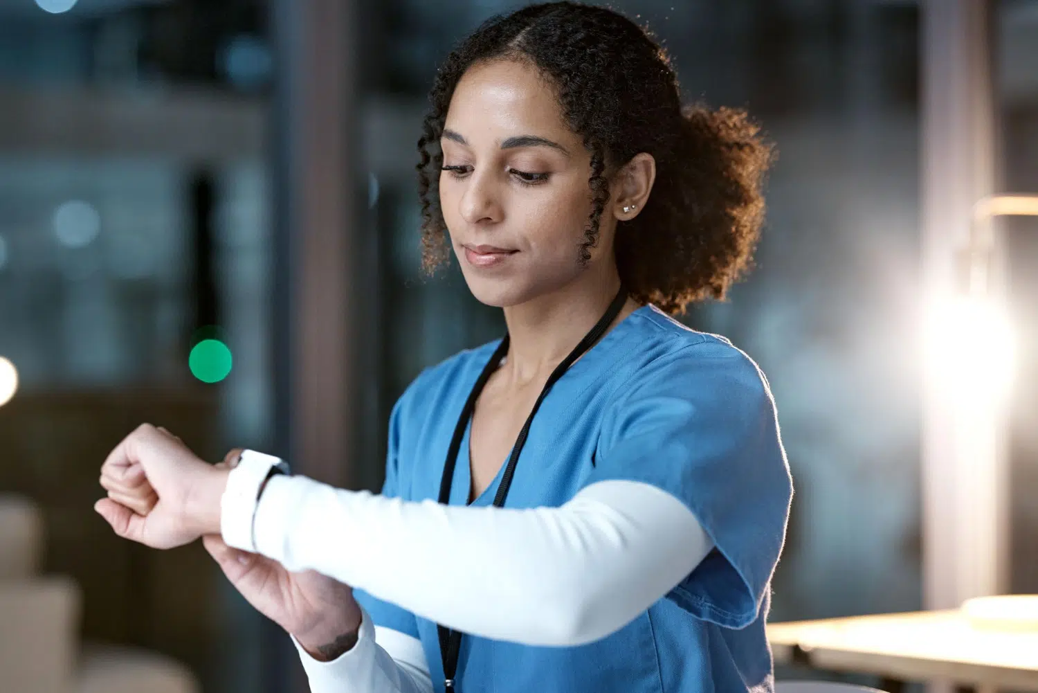 A female doctor checking the time on her watch.