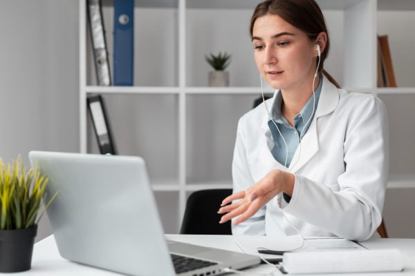 A female doctor doing a video conference to her patient