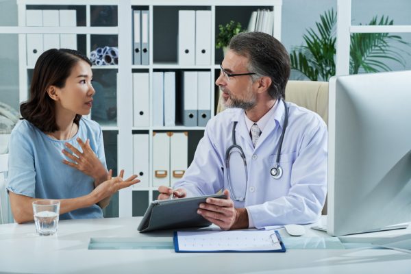 Doctor giving a consultation to his female patient