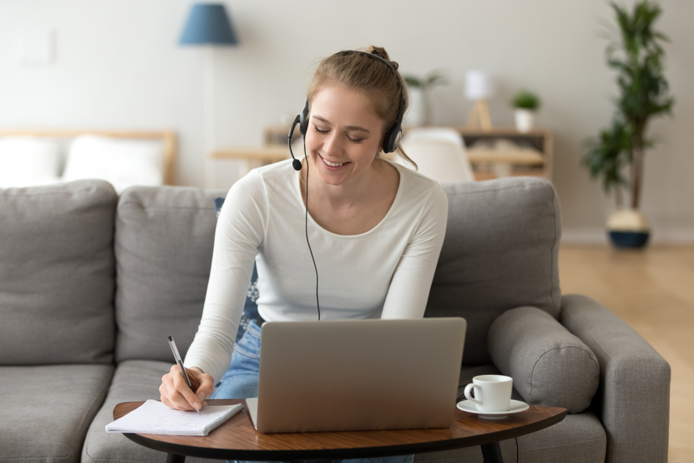 Female transcriptionist working wearing headset .