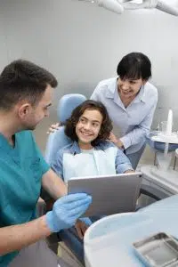 a dentist taking care of his patient, dental office management