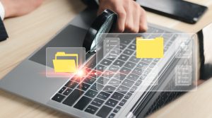 A person using a laptop with a magnifying glass, symbolizing digital investigation or data analysis. The screen displays folder icons and data lists, suggesting organization and search functionality.