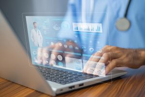 Doctor using computer Document Management System (DMS), online documentation database process automation to efficiently manage files for dental practice management.