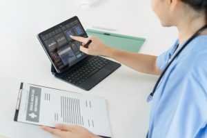 Healthcare Professional Analyzing Patient Data on Digital Tablet, accurate medical transcription services 