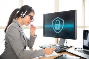 professional receptionist wearing earphone talking with customer and recording the problem to solve cyber security problem.academic transcription services for lecturers