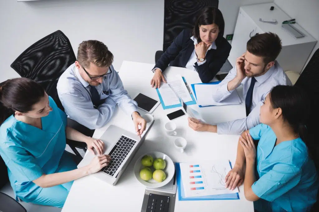 A team of doctors in a meeting discussing medical SEO solutions.