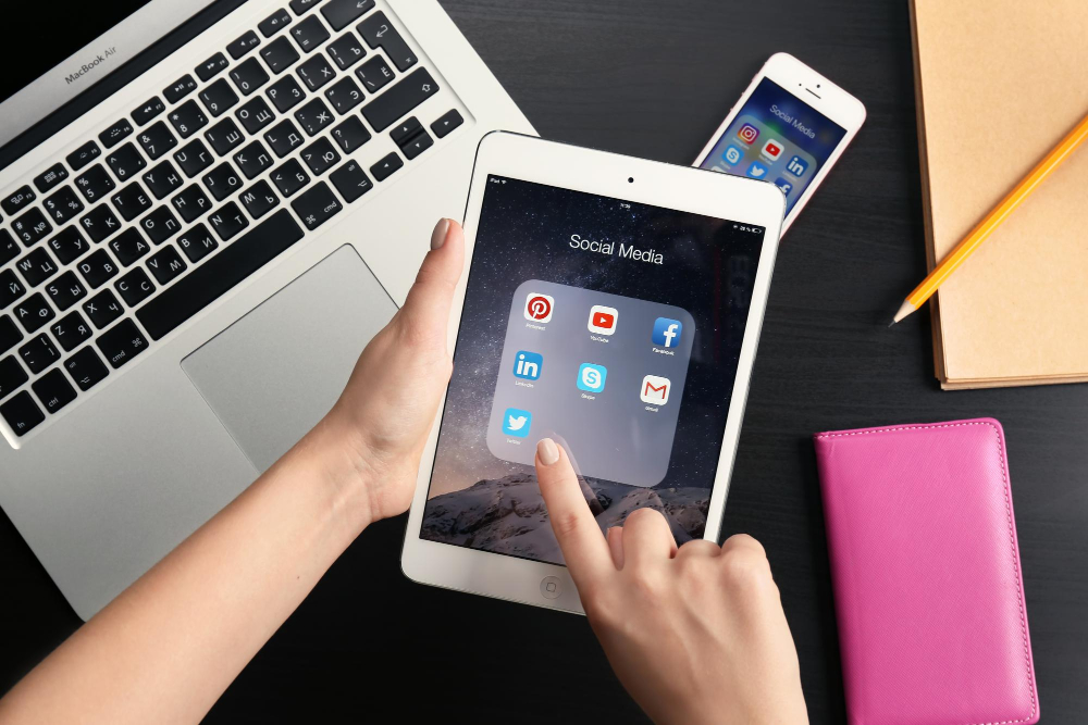 Social media apps on iPad screen on searching medical marketing companies