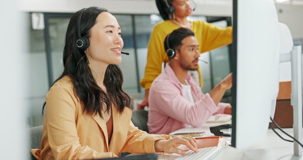Call center, consulting or Asian business woman with computer for telemarketing, customer service or contact us. Communication, sales or crm girl employee at help desk agency for technical support, international medical call handling