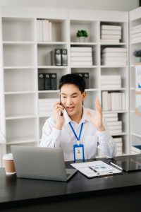 Happy asian businessman have the joy of talking on the smartphone, tablet and laptopon the modern office, black friday efficiency receptionist