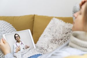 Patient having teleconsultation with doctor, remote clinic management support