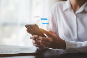 A person is using a smartphone to chat with friends through an application, telecommunication via the Internet on a mobile phone. Concept of using technology in communication