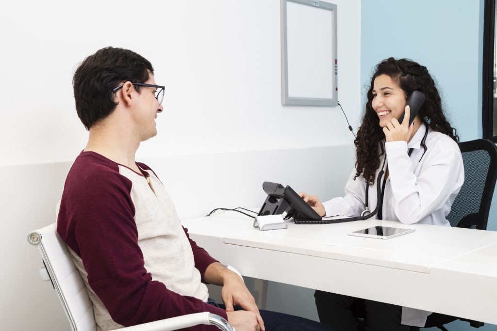 Side view image of a receptionist talking to phone, patient care receptionist