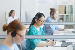 Medical team using headsets while working at their workplace in medical call center.
