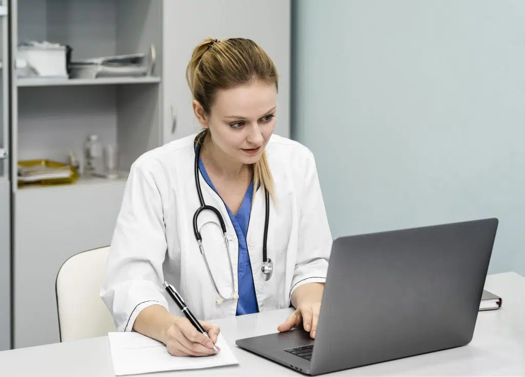 Emergency room scribe using her laptop on the top of desk.